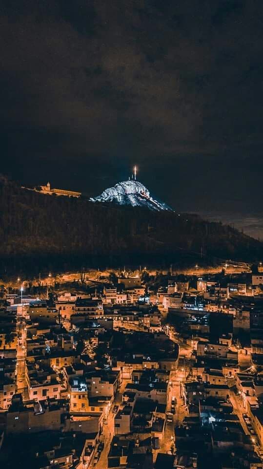 Zacatecas city lights at night under a lit hilltop
