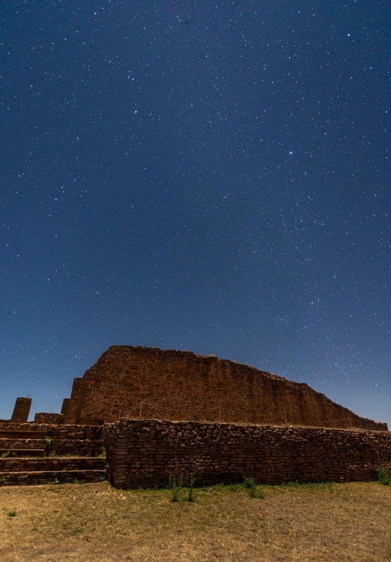 Archaeological stone structure under a starry sky